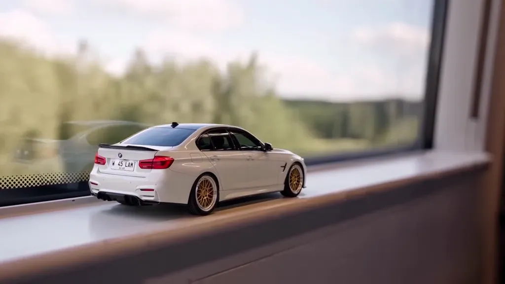 A scale model car on a train window ledge